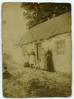 Women and children outside a cottage in Ballabeg