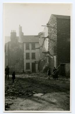 Children and rubble-filled street, Douglas