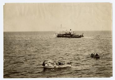 Rowing boats and steamer in Douglas bay