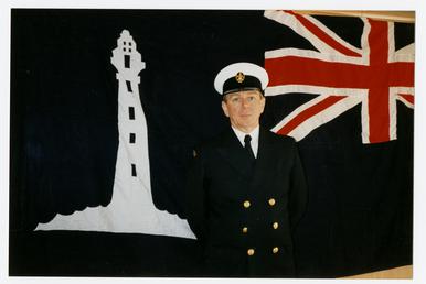 Bob Daggett in front of a lighthouse flag