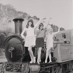Show-girls on steam train