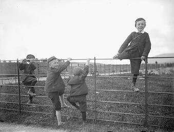 Children playing on a fence, 'Upper Douglas', Isle…