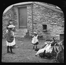 Victorian Children and Woman Feeding Hens on a…