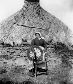 Mary Gilrea at her spinning wheel, Jurby, Isle…