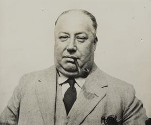 George John Archibald Brown smoking a pipe