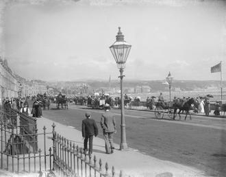 Pedestrians and horse drawn vehicles on Loch Promenade,…