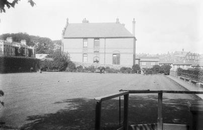Bowling green with large house behind, possibly Derby…