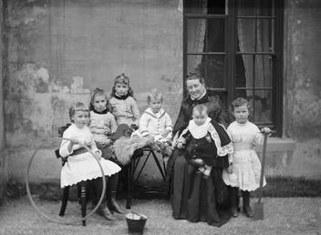 Group portrait of woman with six young children