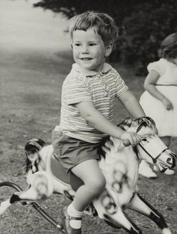 Timothy Ridout astride child's rocking horse pictured outdoors