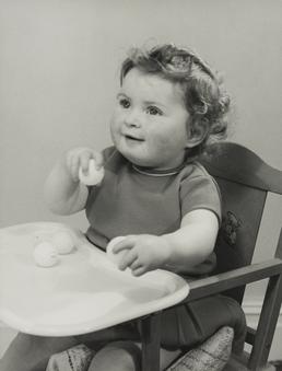 Susan Wheeler, sitting in child's high chair