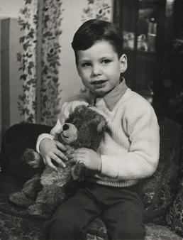 Ian Christian sitting on sofa with cuddly toy