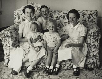 Norman Corlett's five children seated on sofa