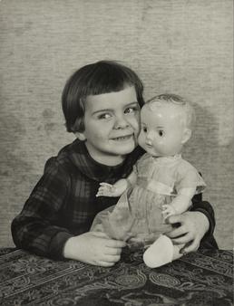 Julie Hancox, seated at table with doll