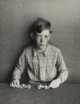 Michael Kelly, seated at table with toy cars