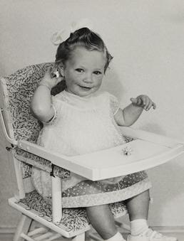 Alison Kinrade, sitting in child's high chair