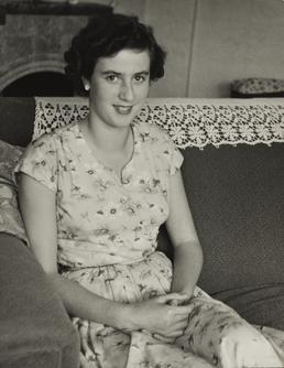 Joy Scott, seated on sofa