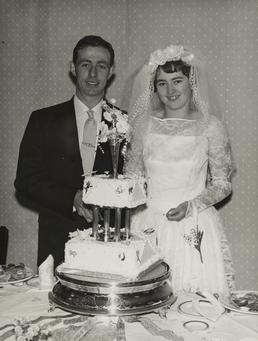 Robert Corkill and Jennifer Harding cutting their wedding…