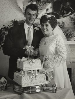 Ewan Corlett and Christine Kelly cutting their wedding…