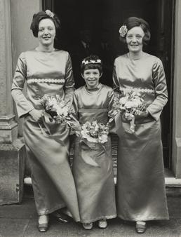 Three bridesmaids outside doorway at wedding of Sylvia…