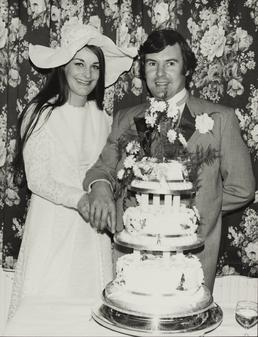 Unidentified couple cutting their wedding cake
