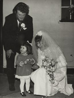Unidentified couple with small girl at their wedding…
