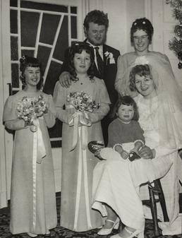 Unidentified couple with small girl and bridesmaids at…