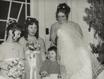 Unidentified bride with bridesmaids and small girl following…
