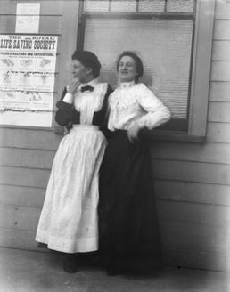 Two female staff members standing outside the Ramsey…