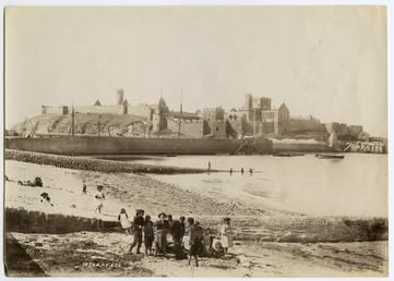 Peel Castle and beach showing children on the…