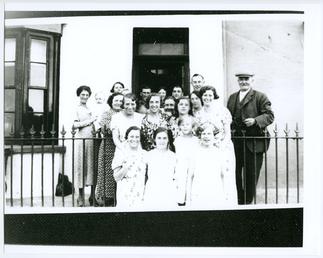 Group outside boarding house at 14 Shore Road,…
