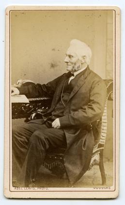 Reverend William Gill seated at a desk
