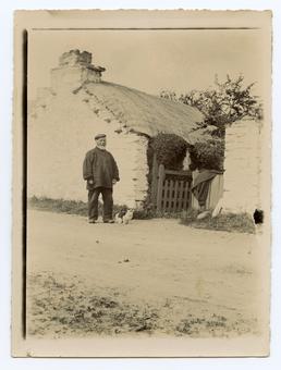 John Kissack outside a cottage