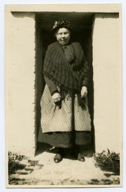 Annie Callium (Kneale?) outside her cottage in Ballagarrett,…
