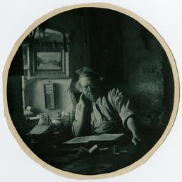 John Kinnish ('Old Pete') reading in his cottage