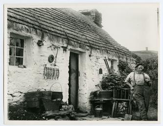 John Kinnish ('Old Pete') standing outside his cottage