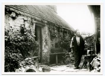 John Kinnish ('Old Pete') outside his cottage