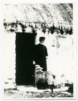 Harry Kelly outside his cottage