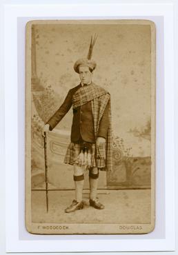 Studio portrait of Archibald Knox in Scottish Dress