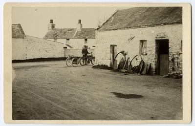 Motor-cyclist outside Cronk smithy, Ballaugh