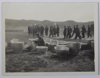 Guard inspecting metal tubs, First World War Internment…